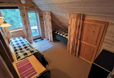 a room with a bed and a door and a window at Topfloor Apartment Separate Entranc Nice view Stord in Fitjar