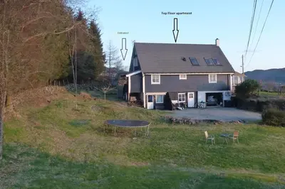 a house with a trampoline in front of it at Topfloor Apartment Separate Entranc Nice view Stord in Fitjar