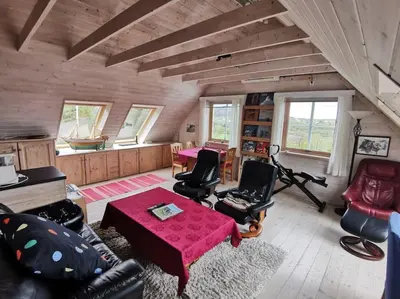 a living room with a couch and a table at Topfloor Apartment Separate Entranc Nice view Stord in Fitjar