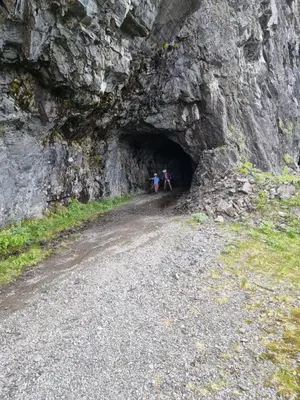 two people standing in a tunnel in a mountain at New, Mountain paradise, biking, alpine touring, skiing in & out in Tyinkrysset