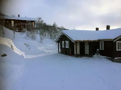 a house with snow on the ground in front of it at New, Mountain paradise, biking, alpine touring, skiing in & out in Tyinkrysset