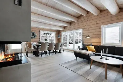 a living room with a couch and a fireplace at Large and luxurious family cabin in Myrkdalen in Helgatun