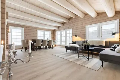 a living room filled with furniture and a wooden wall at Large and luxurious family cabin in Myrkdalen in Helgatun