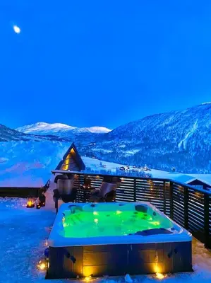 a hot tub on top of a house in the snow at Large and luxurious family cabin in Myrkdalen in Helgatun