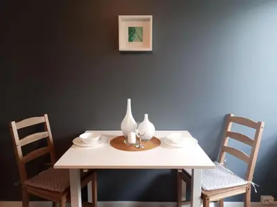 a white table with two vases on top of it at Adorable 1-bedroom apartment with a fantastic view - Free Parking in Trondheim