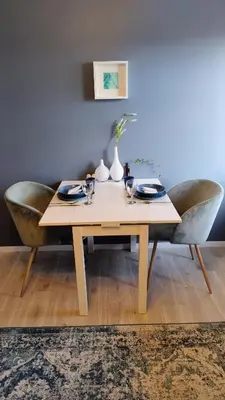 a dining room table with two chairs and a table with plates at Adorable 1-bedroom apartment with a fantastic view - Free Parking in Trondheim