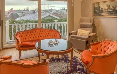 a living room with orange furniture and a balcony at 1 Bedroom Nice Apartment In Hamar in Hamar