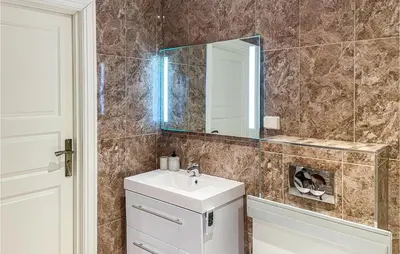 a bathroom with a sink and a mirror at 1 Bedroom Nice Apartment In Hamar in Hamar