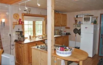a kitchen with wooden cabinets and a white refrigerator at Holiday Home Haugastøl Xxxix in Haugastøl