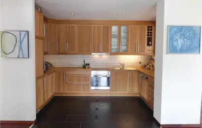 a kitchen with wooden cabinets and a dishwasher at Gorgeous Home In Sveio With Kitchen in Sveio