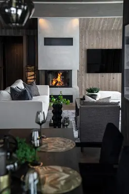 a living room with a couch and a fireplace at The Panorama Retreat - Rindabotn Cabin in Sogndal