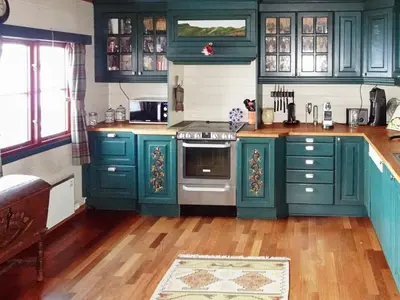 a kitchen with green cabinets and an oven at 10 person holiday home in Svingvoll-By Traum in Svingvoll