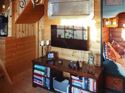 a room with a tv and a book shelf with books at 10 person holiday home in Svingvoll-By Traum in Svingvoll