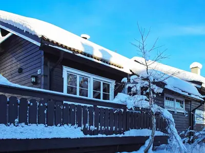 a house covered in snow with a fence at 10 person holiday home in Svingvoll-By Traum in Svingvoll