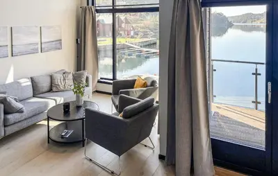 a living room with a couch and a table at 3 Bedroom Awesome Home In Hebnes in Hebnes