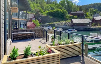 a deck with a view of a marina at 3 Bedroom Awesome Home In Hebnes in Hebnes