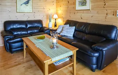a living room with a leather couch and a coffee table at Beautiful Home In Hebnes With Kitchen in Hebnes