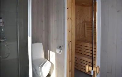a bathroom with a white toilet and a shower at Awesome Home In Rauland With Kitchen in Rauland