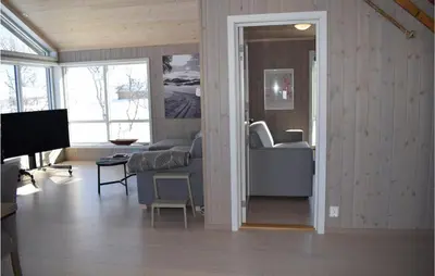 a living room with a couch and a television at Awesome Home In Rauland With Kitchen in Rauland