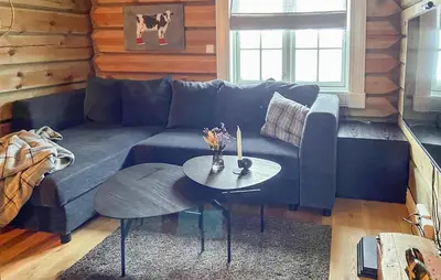 a living room with a blue couch and a table at Lovely Home In Rauland With Sauna in Rauland