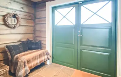a green door in a room with a bench next to it at Lovely Home In Rauland With Sauna in Rauland