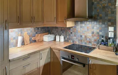 a kitchen with wooden cabinets and a counter top at 3 Bedroom Gorgeous Home In Bykle in Bykle