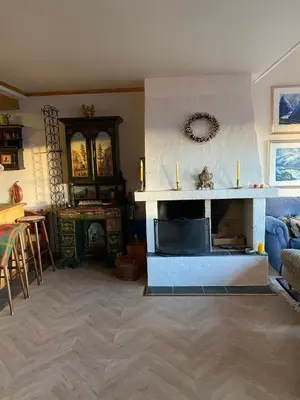 a living room with a fireplace and a table at Apartment City Beitostølen in Beitostøl