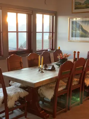a dining room with a wooden table and chairs at Apartment City Beitostølen in Beitostøl