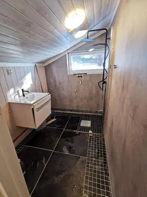 a small bathroom with a sink and a window at Tangen - cabin with 4 bedrooms - great nature in Norheimsund