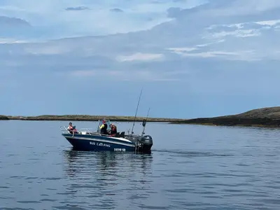 a blue boat floating on a body of water at Bud Camping in Bud