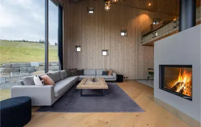 a living room with a couch and a fireplace at Stunning View In Holiday Home in Gol