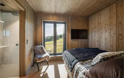 a bedroom with a bed and a window and a shower at Stunning View In Holiday Home in Gol