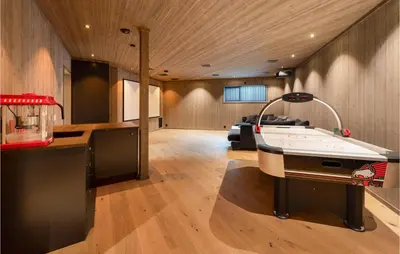 a living room with a ping pong table in the middle at Stunning View In Holiday Home in Gol