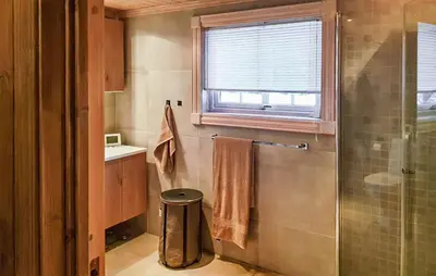 a bathroom with a shower and a sink and a window at Cozy Home In Ulnes With Sauna in Ulnes
