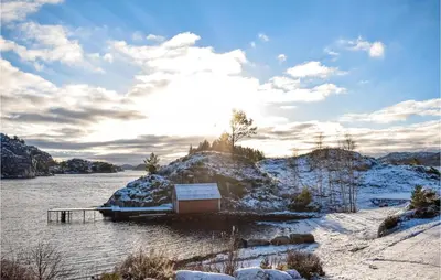 a dock on a river in the snow at 4 Bedroom Cozy Home In Fitjar in Fitjar