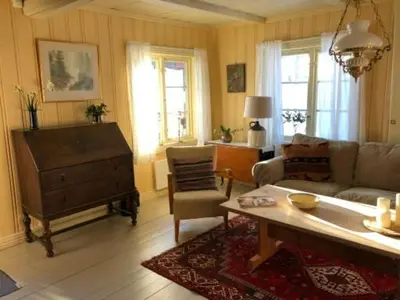 a living room with a couch and a table at Nedre Skogtun cabin by Norgesbooking in Tisleidalen