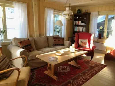 a living room with a couch and a coffee table at Nedre Skogtun cabin by Norgesbooking in Tisleidalen