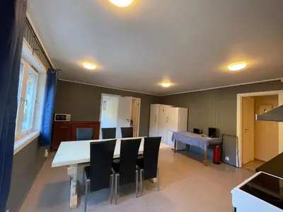 a kitchen with a table and chairs in a room at Leirvik i Sogn-Apartment in Leirvik
