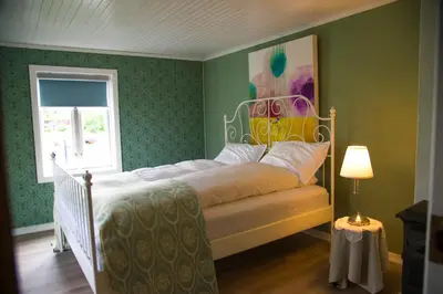 a bedroom with a bed and a window at Lensmannsgården in Namdalseid
