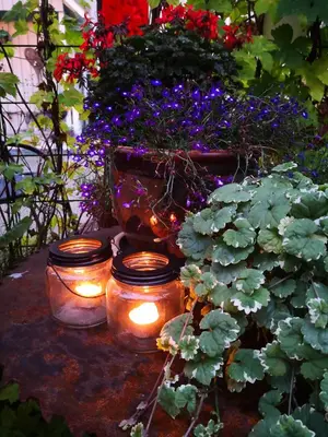 a group of candles and flowers in a garden at Lensmannsgården in Namdalseid