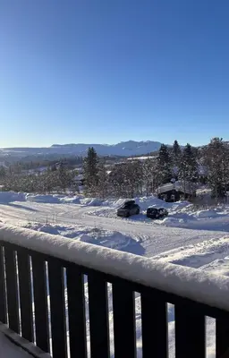 two cars parked in the snow on a balcony at 2 leiligheter med nydelig utsikt og hotell-følelse in Beitostøl