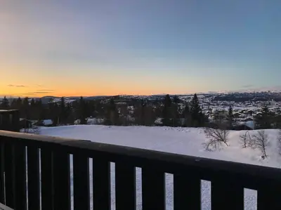 a snow covered balcony with a view of a city at 2 leiligheter med nydelig utsikt og hotell-følelse in Beitostøl