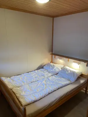 a bed in a room with avertisementatronatronstrationstrationstrationstration at Fagertoppen 6B in Trysil