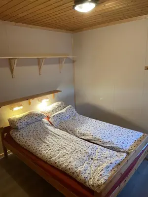 a bed in a bedroom with two pillows on it at Fagertoppen 6B in Trysil