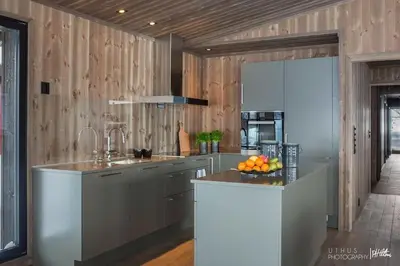 a kitchen with a sink and a counter with fruit on it at Nydelig og Moderne hytte på Kikut Geilo - 6 senger, 4 soverom og jacuzzi in Geilo