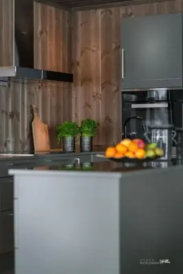 a kitchen with a counter with a plate of fruit at Nydelig og Moderne hytte på Kikut Geilo - 6 senger, 4 soverom og jacuzzi in Geilo