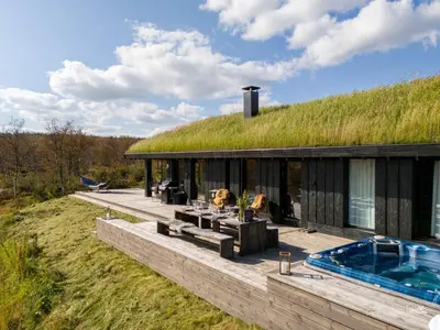 an image of a house with a grass roof at Nydelig og Moderne hytte på Kikut Geilo - 6 senger, 4 soverom og jacuzzi in Geilo