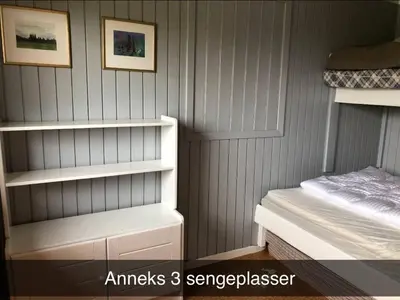 a bedroom with gray walls and a bed and shelves at Koselig familiehytte på vakre Dagali - nær Geilo in Dagali