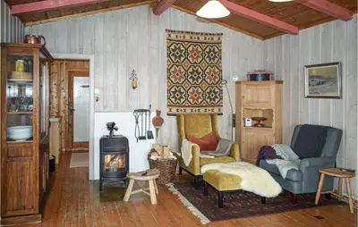 a living room with a couch and a stove at Awesome Home In Ustaoset With Wifi in Ustaoset