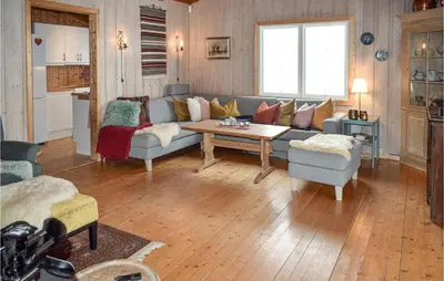a living room with a couch and a table at Awesome Home In Ustaoset With Wifi in Ustaoset